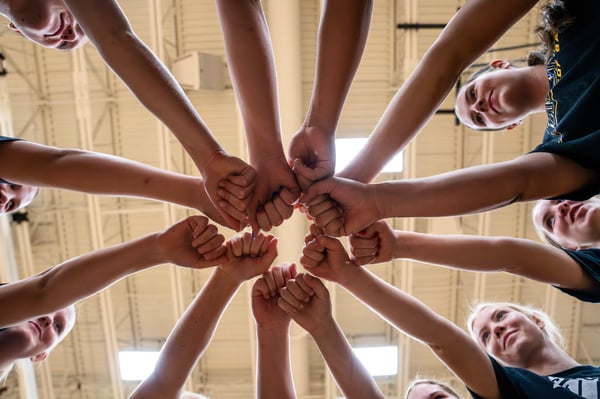 Players Putting Hands in the Middle